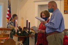 Curtis and Teri lighting advent candles